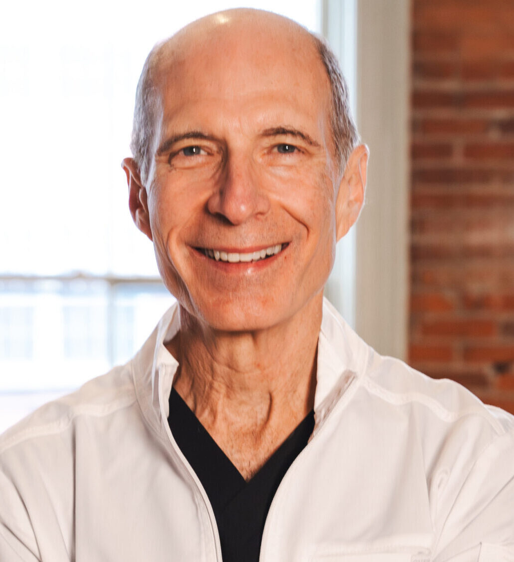 Dentist Smiling bald man in white shirt.