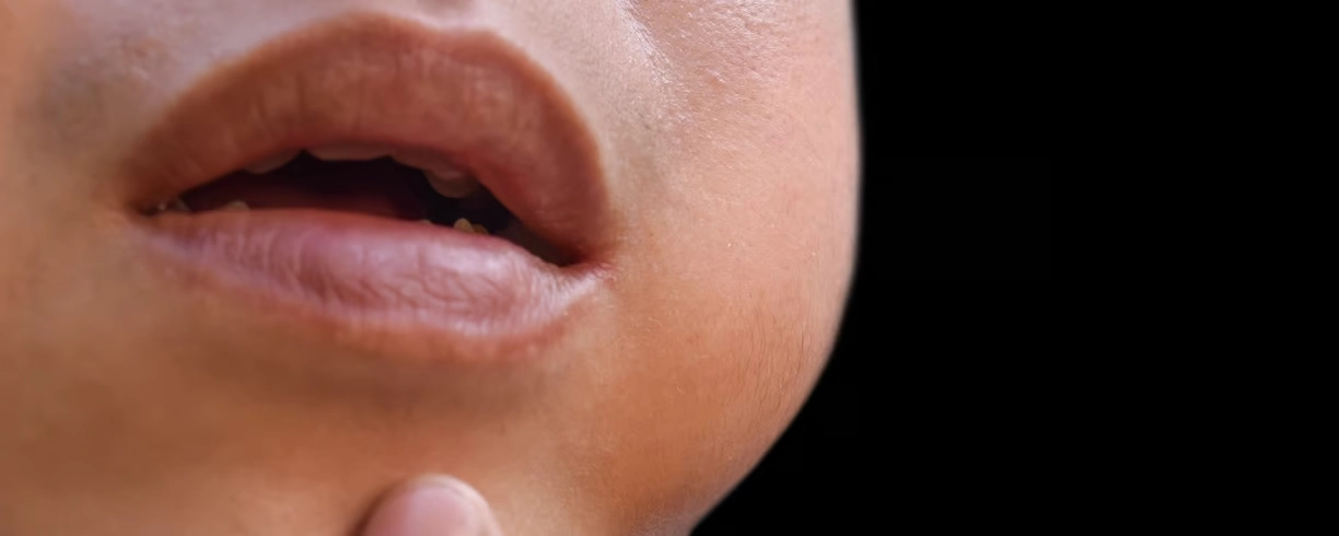 Close-up of a child's mouth slightly open.