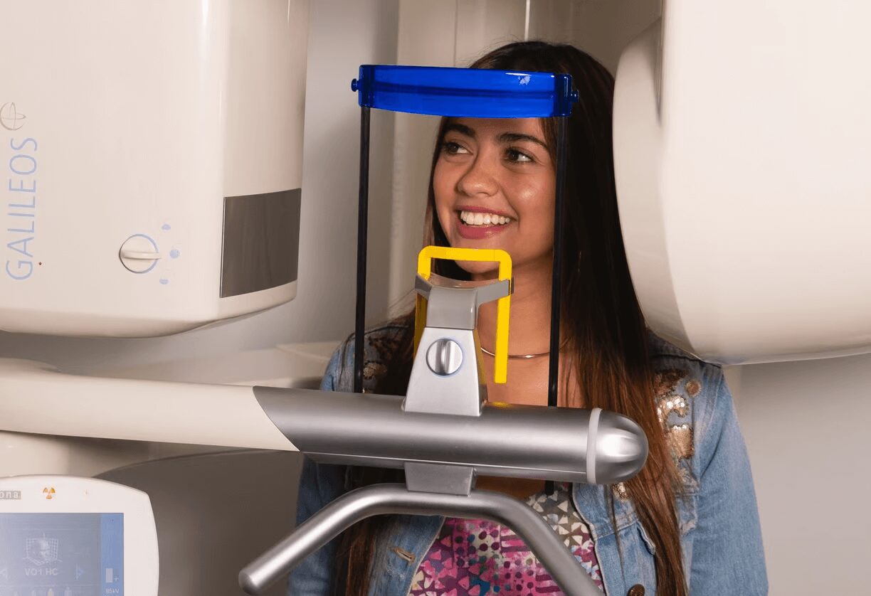 Woman smiling during dental scan.